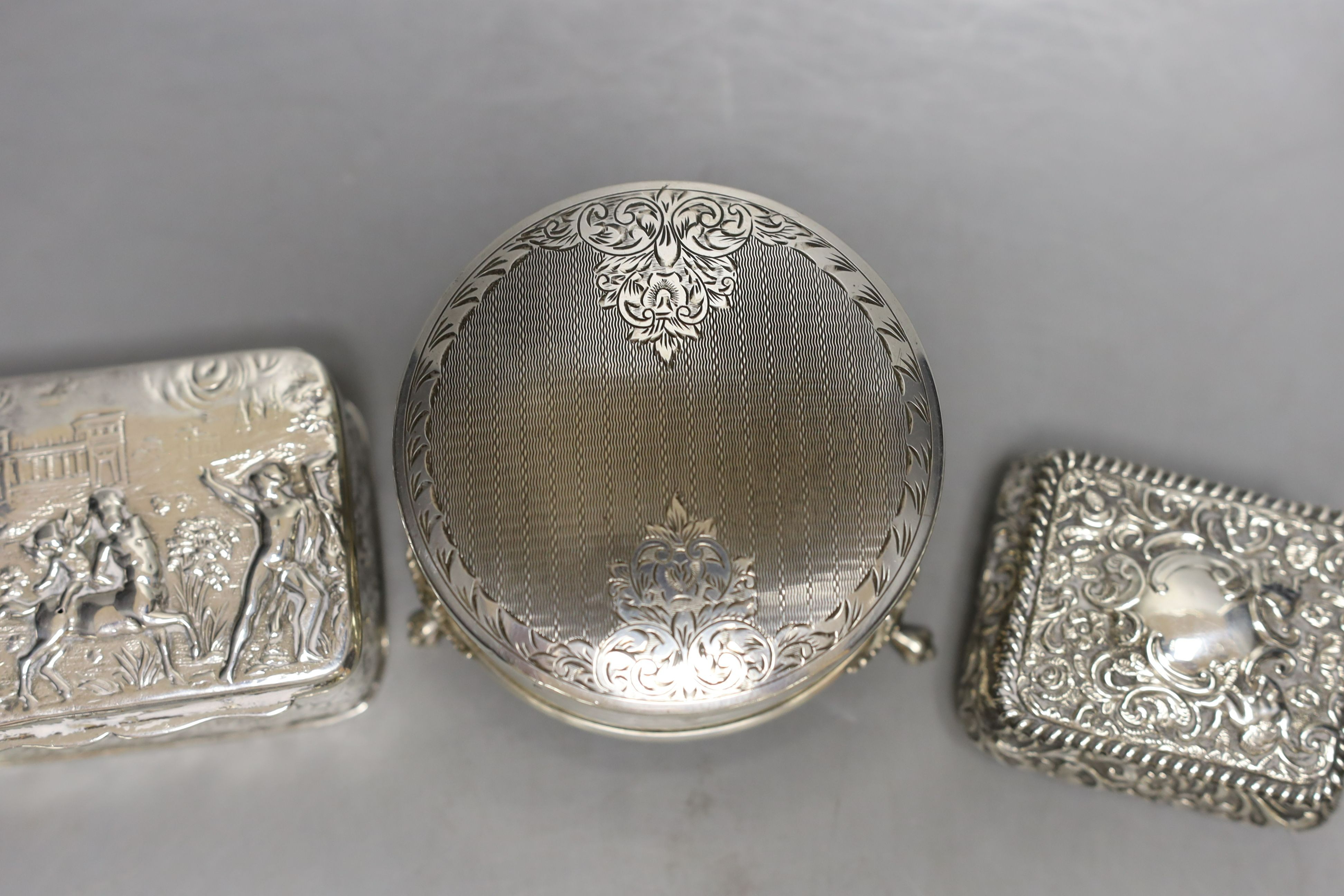 A modern silver mounted trinket box,82mm and two late Victorian embossed silver small boxes.